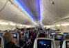 FlyDubai Copilot’s Deleted HATE Posts Uncovered Airplane cabin with passengers seated and seatback screens