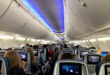 FlyDubai Copilot’s Deleted HATE Posts Uncovered Airplane cabin with passengers seated and seatback screens