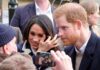 Prince Harry and Meghan, Duchess of Sussex greet people in a crowd