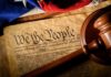 U.S. Constitution with gavel and flag