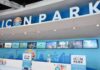 Icon Park ticket counter with blue signage and digital screens