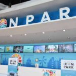 Icon Park ticket counter with blue signage and digital screens