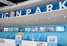 Icon Park ticket counter with blue signage and digital screens