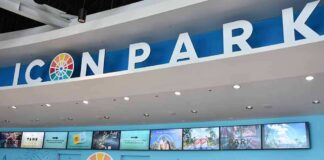Icon Park ticket counter with blue signage and digital screens