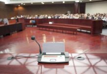 DC Jury Lets Jan 6 Witness WALK Conference microphone on a podium in a courtroom