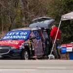 Democrat Staffer Links GOP Senate Ad to KKK Street vendor with car covered in political banners selling T-shirts
