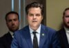 Matt Gaetz speaking at a microphone during a formal meeting