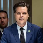 Matt Gaetz speaking at a microphone during a formal meeting