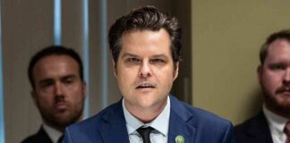 Matt Gaetz speaking at a microphone during a formal meeting