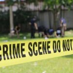 crime scene tape cordoning off a grassy area