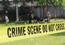 crime scene tape cordoning off a grassy area