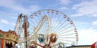 Colorful amusement park scene featuring a ferris wheel and carousel