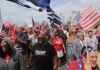 Dennis Erickson, Carlos Hyde, and Danny Hope among a crowd at a patriotic rally