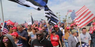 Dennis Erickson, Carlos Hyde, and Danny Hope among a crowd at a patriotic rally